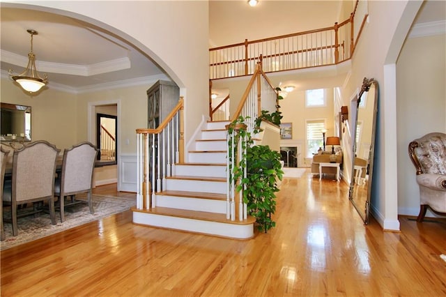 6765 Crofton Dr, Alpharetta, GA 30005 - entryway featuring stairs, wood finished floors, ornamental molding, arched walkways, and a high ceiling