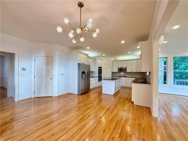 6765 Crofton Dr, Alpharetta, GA 30005 - kitchen with stainless steel appliances, a sink, crown molding, dark countertops, and a chandelier