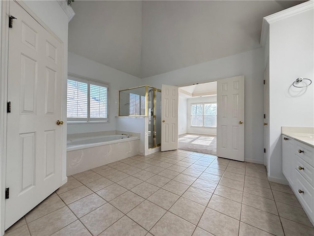 6765 Crofton Dr, Alpharetta, GA 30005 - bathroom with tile patterned floors, vanity, a shower stall, a garden tub, and vaulted ceiling