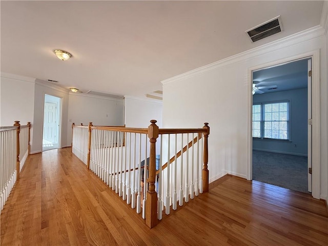 6765 Crofton Dr, Alpharetta, GA 30005 - hall with light wood finished floors, baseboards, crown molding, and an upstairs landing