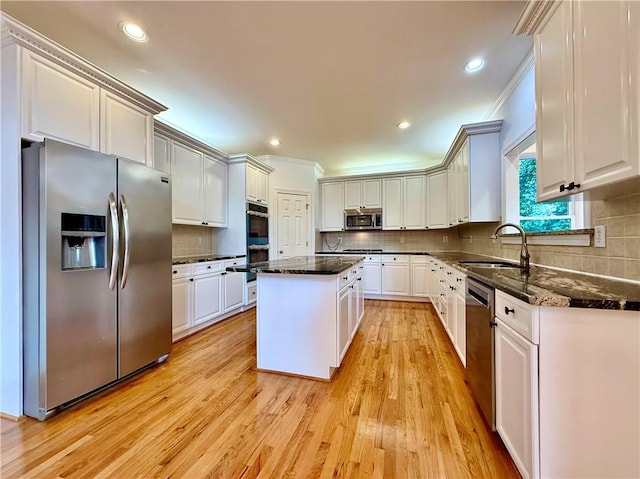 6765 Crofton Dr, Alpharetta, GA 30005 - kitchen featuring stainless steel appliances, a sink, ornamental molding, backsplash, and a center island