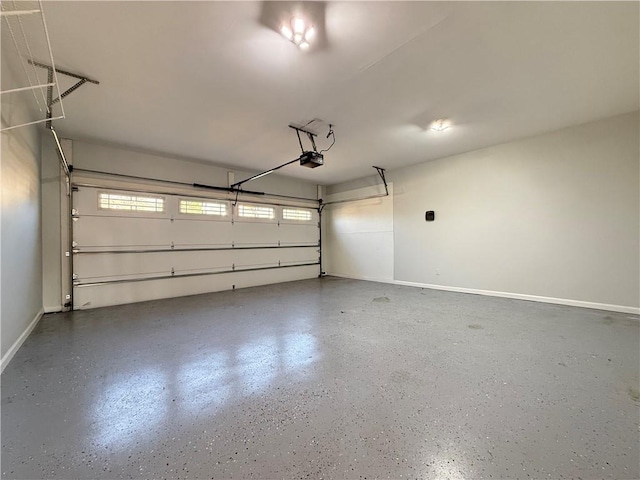 6765 Crofton Dr, Alpharetta, GA 30005 - garage with a garage door opener and baseboards