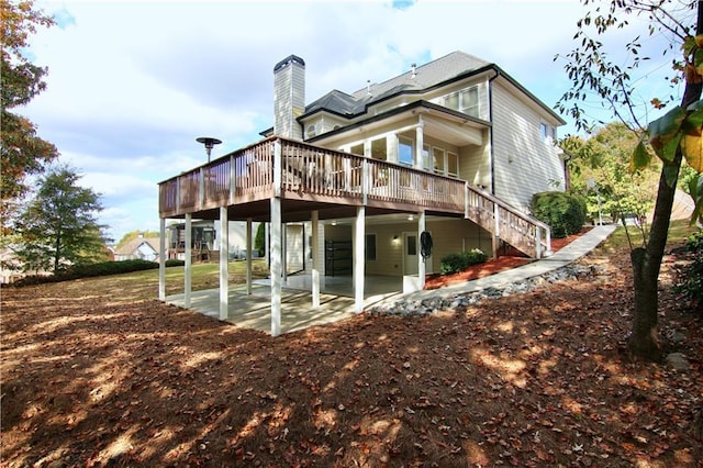 6765 Crofton Dr, Alpharetta, GA 30005 - rear view of house with a patio, a deck, a chimney, and stairway