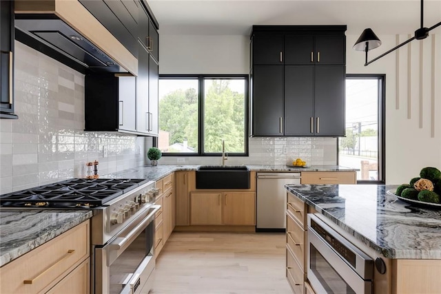 3960 Clairmont Rd Unit 2, Chamblee, GA 30341 - kitchen with stainless steel appliances, a sink, light stone countertops, backsplash, and dark cabinets