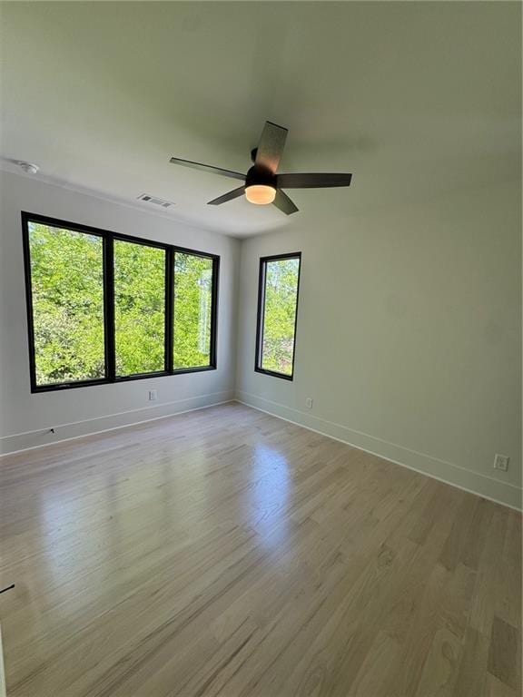 3960 Clairmont Rd Unit 2, Chamblee, GA 30341 - spare room with light wood finished floors, baseboards, and a ceiling fan