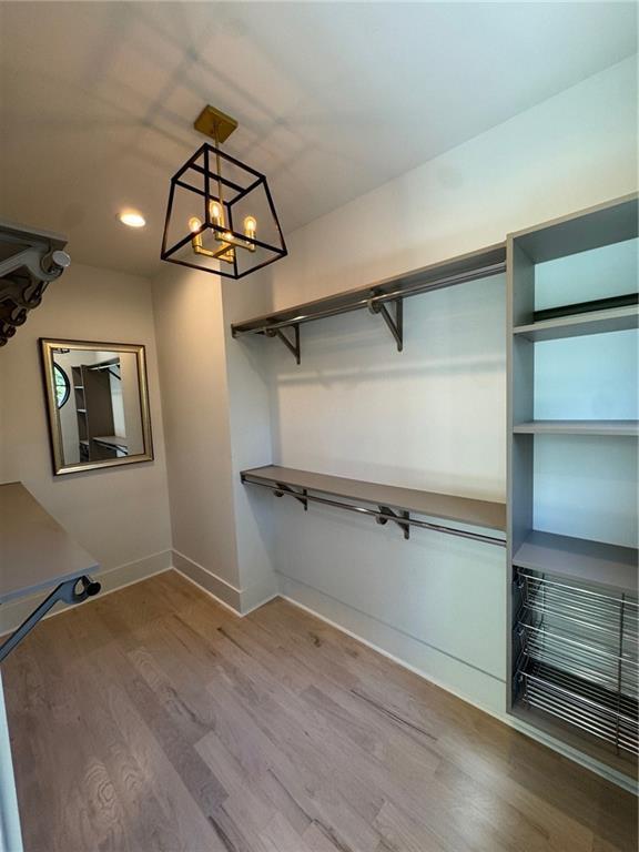 3960 Clairmont Rd Unit 2, Chamblee, GA 30341 - walk in closet with wood finished floors and a chandelier