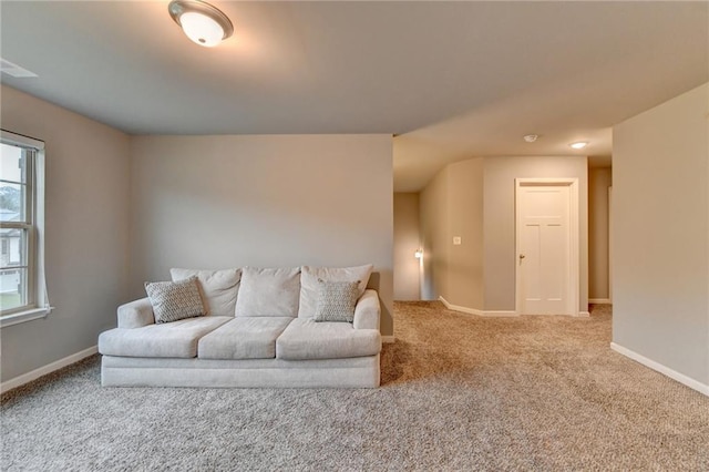 carpeted living area with baseboards