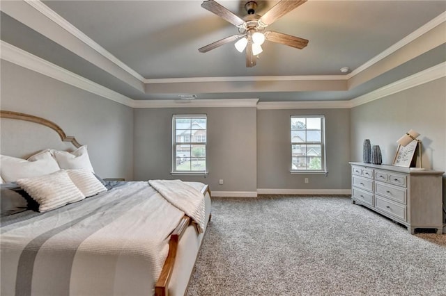 bedroom featuring a raised ceiling, light colored carpet, baseboards, a ceiling fan, and ornamental molding