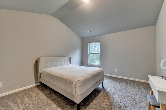 carpeted bedroom with lofted ceiling and baseboards