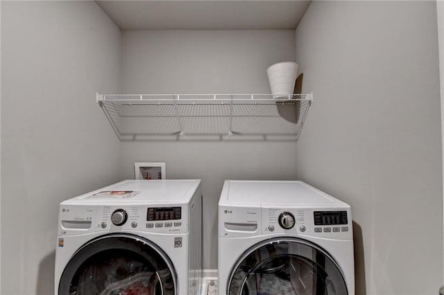 clothes washing area featuring washer and clothes dryer