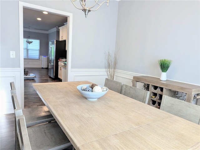 3419 Mulberry Cove Way, Auburn, GA 30011 - dining room with a wainscoted wall, a decorative wall, crown molding, dark wood-style floors, and a chandelier