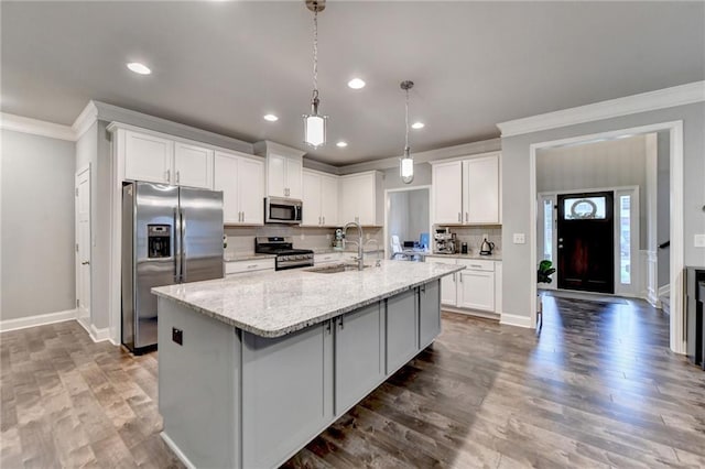 3419 Mulberry Cove Way, Auburn, GA 30011 - kitchen featuring stainless steel appliances, crown molding, a sink, white cabinetry, and a large island with sink