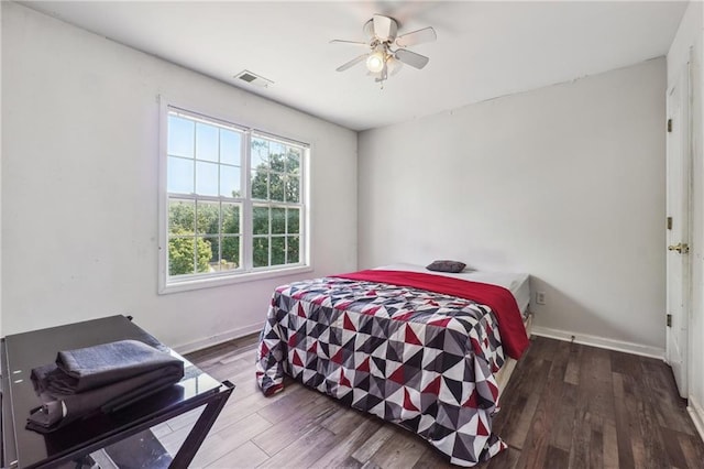 bedroom with wood finished floors, baseboards, and ceiling fan