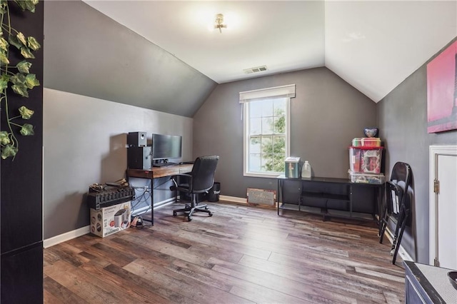 office area featuring wood finished floors, vaulted ceiling, and baseboards