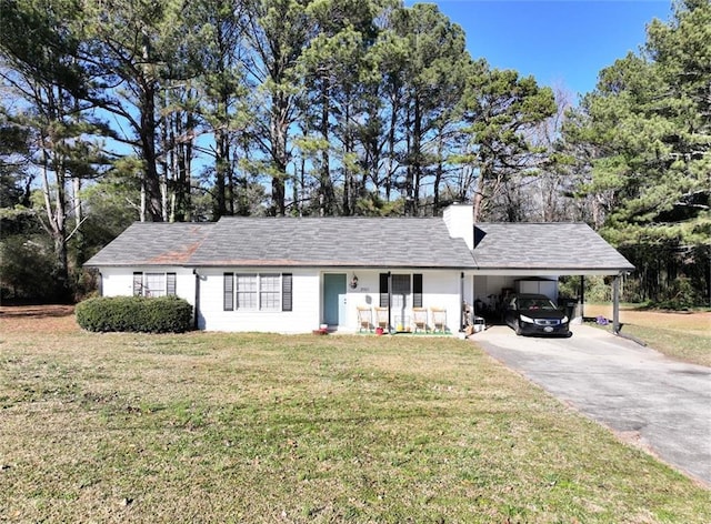 ranch-style house featuring a carport and a front yard