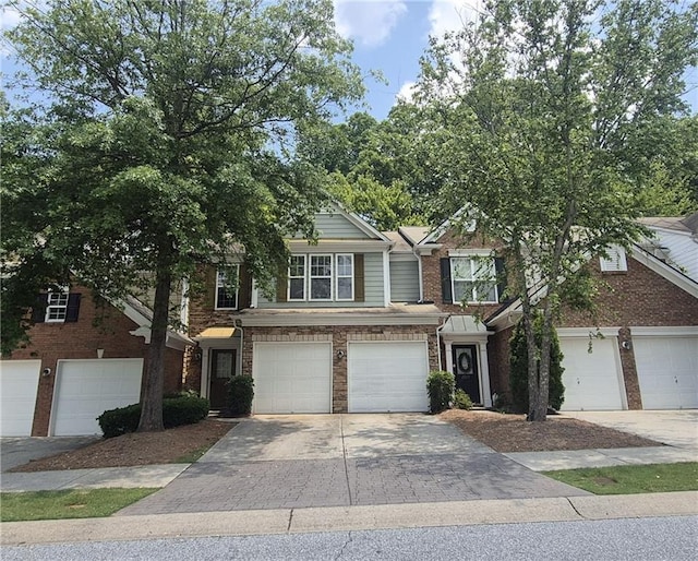 2061 Fosco Dr, Duluth, GA 30097 - view of front of home with driveway, brick siding, and an attached garage