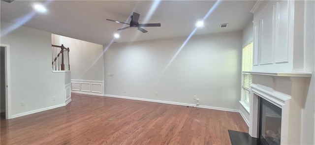 2061 Fosco Dr, Duluth, GA 30097 - unfurnished living room featuring a ceiling fan, a fireplace with flush hearth, wood finished floors, and baseboards