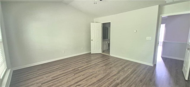 2061 Fosco Dr, Duluth, GA 30097 - unfurnished bedroom featuring dark wood finished floors, vaulted ceiling, and baseboards
