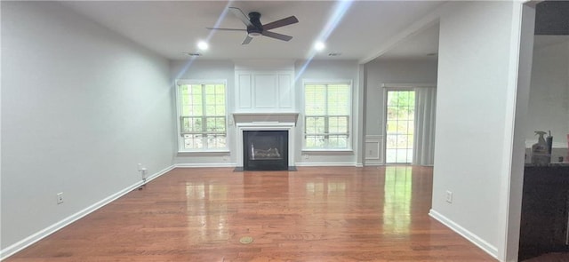 2061 Fosco Dr, Duluth, GA 30097 - unfurnished living room featuring a fireplace with flush hearth, a ceiling fan, wood finished floors, and baseboards