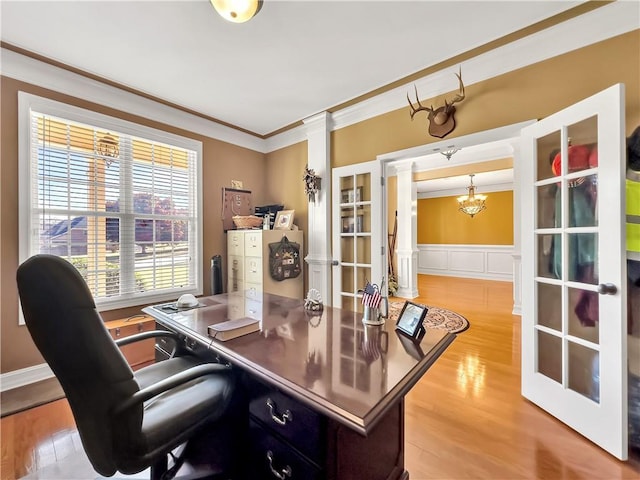 office area with ornate columns, french doors, wood finished floors, and crown molding