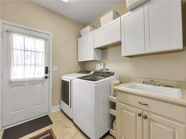 laundry room featuring light tile patterned flooring, separate washer and dryer, a sink, baseboards, and cabinet space