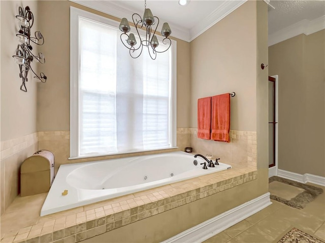 bathroom with tile patterned flooring, crown molding, a jetted tub, and an inviting chandelier