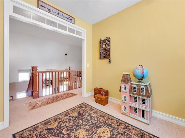 rec room with carpet flooring and baseboards