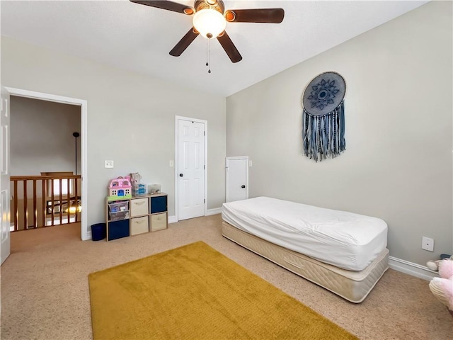 carpeted bedroom featuring a ceiling fan and baseboards