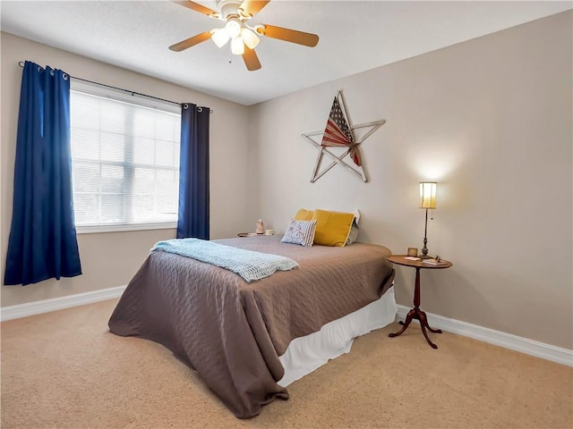 carpeted bedroom with a ceiling fan and baseboards