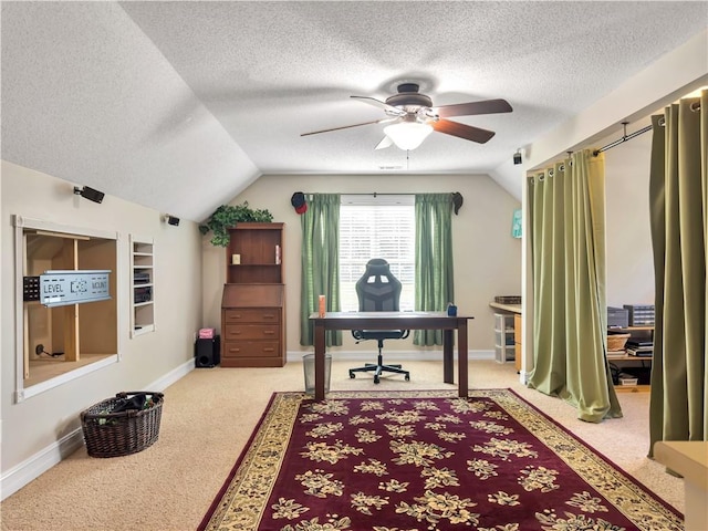 office featuring lofted ceiling, a textured ceiling, light colored carpet, a ceiling fan, and baseboards