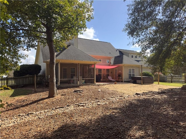 back of property with a sunroom, a patio area, and fence