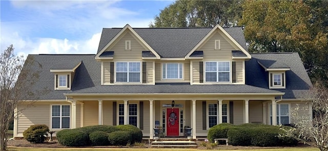 view of front of home with a porch and roof with shingles