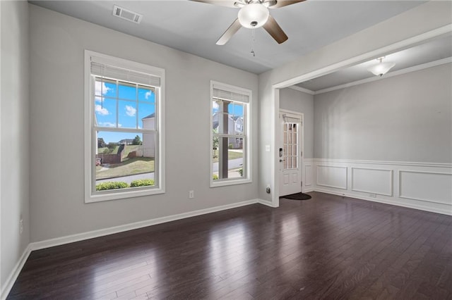 spare room featuring visible vents, baseboards, ceiling fan, and wood finished floors