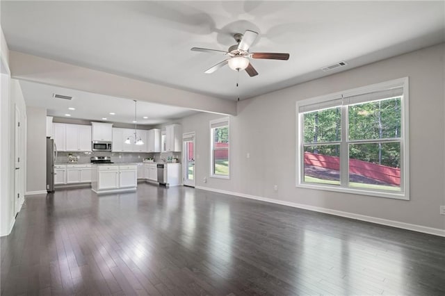unfurnished living room with visible vents, a ceiling fan, and baseboards