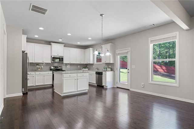 kitchen with visible vents, light countertops, appliances with stainless steel finishes, and dark wood-type flooring