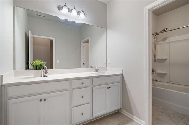 full bathroom with double vanity, visible vents, a sink, tile patterned floors, and baseboards