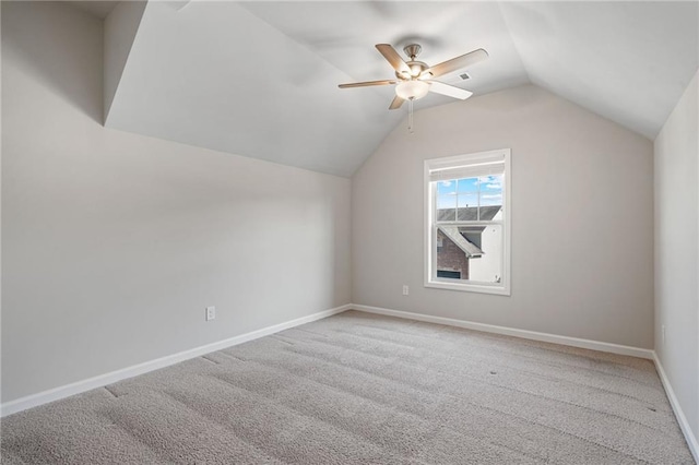 bonus room with a ceiling fan, baseboards, vaulted ceiling, and light carpet