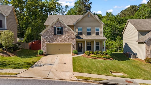 view of front of home with an attached garage, concrete driveway, a front lawn, and brick siding
