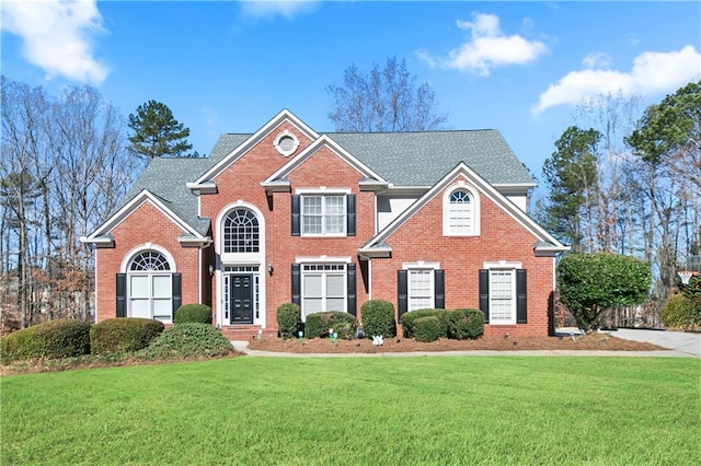 325 Stonecastle Pass, South Fulton, GA 30331 - view of front of home featuring brick siding, a shingled roof, and a front lawn