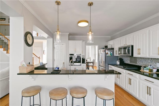 325 Stonecastle Pass, South Fulton, GA 30331 - kitchen featuring light wood-type flooring, a breakfast bar area, and stainless steel appliances