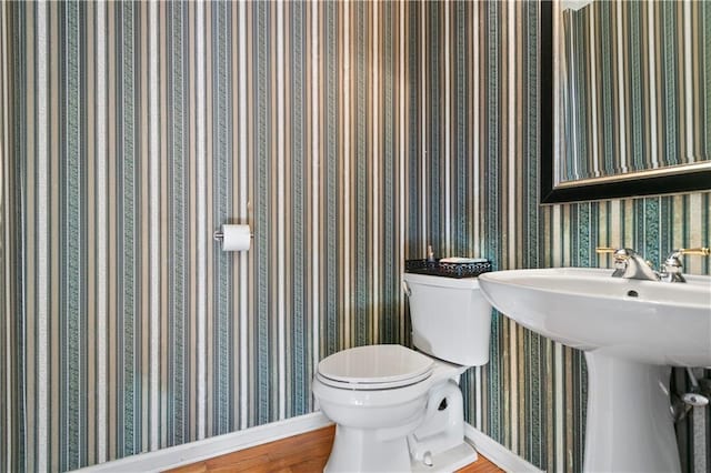 325 Stonecastle Pass, South Fulton, GA 30331 - half bathroom with baseboards, wallpapered walls, toilet, and a sink