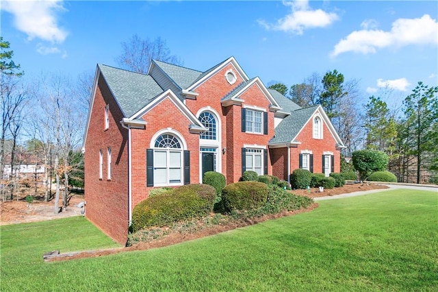 325 Stonecastle Pass, South Fulton, GA 30331 - view of front of home featuring a front lawn, a shingled roof, and brick siding