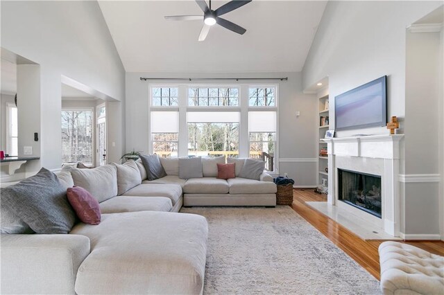 325 Stonecastle Pass, South Fulton, GA 30331 - living room featuring a high end fireplace, high vaulted ceiling, wood finished floors, and a ceiling fan