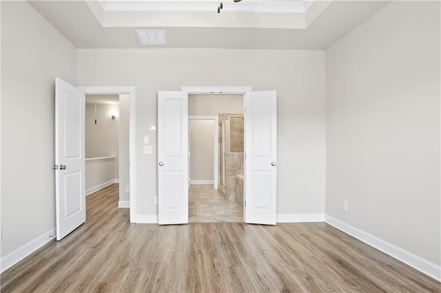 3657 Atherton Park Ct, Suwanee, GA 30024 - unfurnished bedroom featuring a raised ceiling and wood finished floors