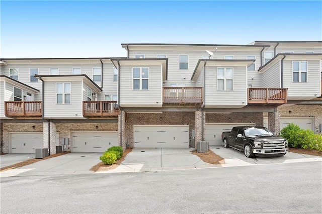 3657 Atherton Park Ct, Suwanee, GA 30024 - rear view of property with a garage, concrete driveway, and brick siding