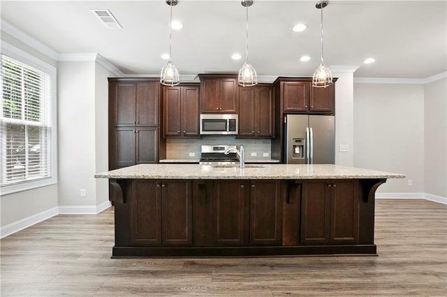 3657 Atherton Park Ct, Suwanee, GA 30024 - kitchen with appliances with stainless steel finishes, ornamental molding, light wood-style floors, decorative backsplash, and dark brown cabinets