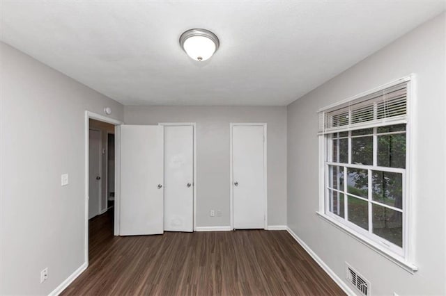 1338 Georgia Ave, Atlanta, GA 30344 - unfurnished bedroom featuring dark wood finished floors and baseboards
