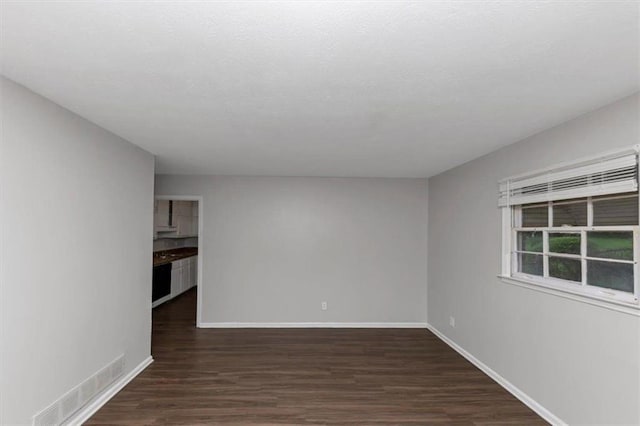 1338 Georgia Ave, Atlanta, GA 30344 - unfurnished living room with dark wood-style floors and baseboards
