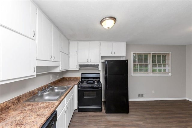 1338 Georgia Ave, Atlanta, GA 30344 - kitchen featuring black appliances, under cabinet range hood, dark wood-type flooring, and white cabinetry