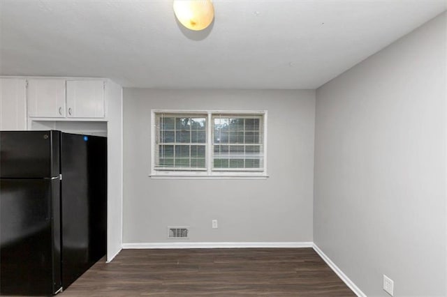 1338 Georgia Ave, Atlanta, GA 30344 - kitchen featuring freestanding refrigerator, dark wood-style floors, and white cabinetry